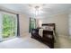 Relaxing bedroom with a large window, comfortable furniture, and scenic wooded views at 4311 N Elizabeth Se Ln, Atlanta, GA 30339