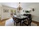 Bright dining room features a traditional chandelier, glass table, and French doors to outside at 4311 N Elizabeth Se Ln, Atlanta, GA 30339
