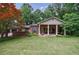Charming brick home features a columned front porch and lush green lawn at 4311 N Elizabeth Se Ln, Atlanta, GA 30339
