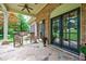 Charming covered porch with stone flooring, rocking chairs, and lush landscaping at 4311 N Elizabeth Se Ln, Atlanta, GA 30339