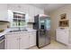 Kitchen featuring white cabinets, stainless steel refrigerator, and stainless steel sink at 4311 N Elizabeth Se Ln, Atlanta, GA 30339