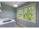 Laundry room with modern washer and a view of the green scenery through the window at 4311 N Elizabeth Se Ln, Atlanta, GA 30339