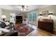 Bright living room with hardwood floors, decorative rug, ceiling fan and french doors to deck at 4311 N Elizabeth Se Ln, Atlanta, GA 30339