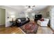 Spacious living room with hardwood floors, a fireplace, and French doors to outside at 4311 N Elizabeth Se Ln, Atlanta, GA 30339