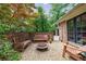 Enclosed outdoor brick patio with gravel, built-in benches, and a small fire pit at 4311 N Elizabeth Se Ln, Atlanta, GA 30339