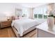 Bright bedroom with large windows, hardwood floors, a comfortable bed, and neutral décor at 506 Motivation Nw Cir, Atlanta, GA 30309