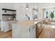 Bright kitchen featuring a large center island, stainless steel appliances and hardwood floors throughout at 506 Motivation Nw Cir, Atlanta, GA 30309