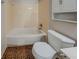 Cozy bathroom featuring a tub-shower and neutral-tone tiling at 228 Amour Sw Way, Lilburn, GA 30047