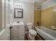 Cozy bathroom with a vanity, mirror, toilet, and tiled shower-tub combination at 228 Amour Sw Way, Lilburn, GA 30047