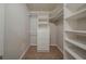 Walk-in closet boasts built-in shelving and drawers for optimal storage solutions at 228 Amour Sw Way, Lilburn, GA 30047