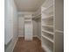 Walk-in closet boasts built-in shelving and drawers for optimal storage solutions at 228 Amour Sw Way, Lilburn, GA 30047
