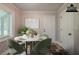 Cozy dining area features a modern round table, stylish chairs, and natural light from the window at 228 Amour Sw Way, Lilburn, GA 30047