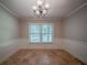 Bright dining room featuring tile flooring, wainscoting, and an elegant chandelier at 228 Amour Sw Way, Lilburn, GA 30047