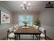 Virtually staged dining room with stylish decor, perfect for elegant gatherings and dinner parties at 228 Amour Sw Way, Lilburn, GA 30047