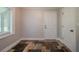 Hallway features stone tile flooring, baseboards, and a well-lit interior at 228 Amour Sw Way, Lilburn, GA 30047