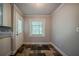 Bright kitchen area features stone tile flooring and a view to the backyard at 228 Amour Sw Way, Lilburn, GA 30047