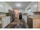 Well-lit kitchen features stainless steel appliances, stone tile flooring, and white cabinetry at 228 Amour Sw Way, Lilburn, GA 30047