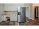 Spacious kitchen offers built-in desk area, stainless steel fridge and ample cabinet space at 228 Amour Sw Way, Lilburn, GA 30047