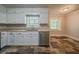 Kitchen features stone tile flooring, stainless steel appliances, and ample cabinet space at 228 Amour Sw Way, Lilburn, GA 30047