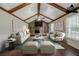 Staged living room with stone fireplace, wood beams, sofas, and stylish decor at 228 Amour Sw Way, Lilburn, GA 30047