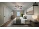 Staged bedroom features plush bedding, dresser, wall art, and neutral color scheme at 228 Amour Sw Way, Lilburn, GA 30047
