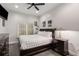 Cozy bedroom with a dark wood dresser, nightstand, and a queen size bed with white comforter at 2871 Parkridge Ne, Brookhaven, GA 30319