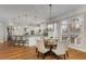 Open dining area with a modern chandelier, white trim, large windows, and seamless access to the kitchen at 2871 Parkridge Ne, Brookhaven, GA 30319