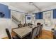 Dining room featuring blue walls, wainscoting, hardwood floors, and large table with seating at 2871 Parkridge Ne, Brookhaven, GA 30319