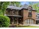 Beautiful brick home with a covered porch, arched garage, and mature landscaping creating a welcoming curb appeal at 2871 Parkridge Ne, Brookhaven, GA 30319