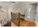 Upstairs landing with hardwood floors and detailed railing, leading to the bathroom and staircase at 2871 Parkridge Ne, Brookhaven, GA 30319