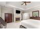 Spacious main bedroom with a fireplace, built-in cabinets, and tray ceilings at 2871 Parkridge Ne, Brookhaven, GA 30319