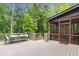 Outdoor deck area featuring a dining table set and view of the surrounding trees at 2871 Parkridge Ne, Brookhaven, GA 30319