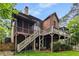 Two-story home with wooden deck and screened porch that overlooks the backyard at 2871 Parkridge Ne, Brookhaven, GA 30319