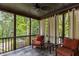 Screened porch with slate floors, ceiling fan, and comfortable seating area, offering backyard views at 2871 Parkridge Ne, Brookhaven, GA 30319