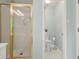 Bright bathroom featuring a gold-trimmed glass shower and a separate toilet area at 3270 Golfe Links Dr, Snellville, GA 30039