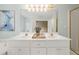 Elegant bathroom featuring a double vanity, a large mirror, and tasteful decor at 3270 Golfe Links Dr, Snellville, GA 30039