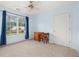 Cozy bedroom with blue walls, carpet flooring, and a window offering a view of the outdoors at 3270 Golfe Links Dr, Snellville, GA 30039