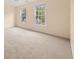 Spacious carpeted bedroom featuring plenty of natural light from its two windows at 3270 Golfe Links Dr, Snellville, GA 30039