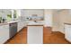Bright kitchen featuring white cabinets, stainless steel appliances, and hardwood floors at 3270 Golfe Links Dr, Snellville, GA 30039