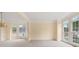 Bright living room featuring large bay windows, neutral carpet, and ample natural light at 3270 Golfe Links Dr, Snellville, GA 30039