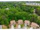 An aerial view of beautiful single-Gathering homes nestled among lush green trees in a serene neighborhood at 4876 Briarcliff Dr, Sugar Hill, GA 30518