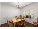 Formal dining room with hardwood floors, wainscoting, and a chandelier at 4876 Briarcliff Dr, Sugar Hill, GA 30518