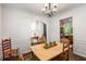Dining room featuring an archway to the foyer and another to the kitchen, hardwood floors, neutral walls at 4876 Briarcliff Dr, Sugar Hill, GA 30518