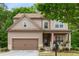 Charming two-story home featuring a covered front porch and well-maintained landscaping at 4876 Briarcliff Dr, Sugar Hill, GA 30518