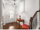 Bright foyer featuring hardwood floors, wainscoting, and a staircase with iron spindles at 4876 Briarcliff Dr, Sugar Hill, GA 30518