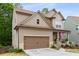 Charming home featuring a covered porch, landscaped front yard, and a two-car garage at 4876 Briarcliff Dr, Sugar Hill, GA 30518