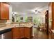 Bright, open kitchen with granite countertops and stainless steel dishwasher, with a view to the living room at 4876 Briarcliff Dr, Sugar Hill, GA 30518