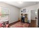 Comfortable home office with hardwood floors, colorful rug, and lots of natural light at 4876 Briarcliff Dr, Sugar Hill, GA 30518