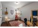 Cozy home office with hardwood floors, colorful rug, guitar, and lots of personality and light at 4876 Briarcliff Dr, Sugar Hill, GA 30518