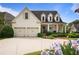 Traditional white brick home with a covered front porch, two-car garage, and well-maintained landscaping at 1021 Bluffhaven Ne Way, Atlanta, GA 30319